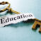 Closeup of a key and paper note with Education text