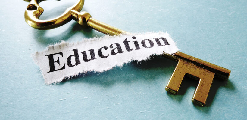 Closeup of a key and paper note with Education text